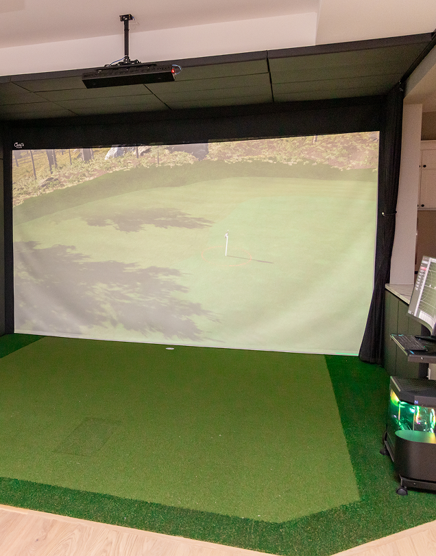 Indoor golf simulator projection screen and turf.
